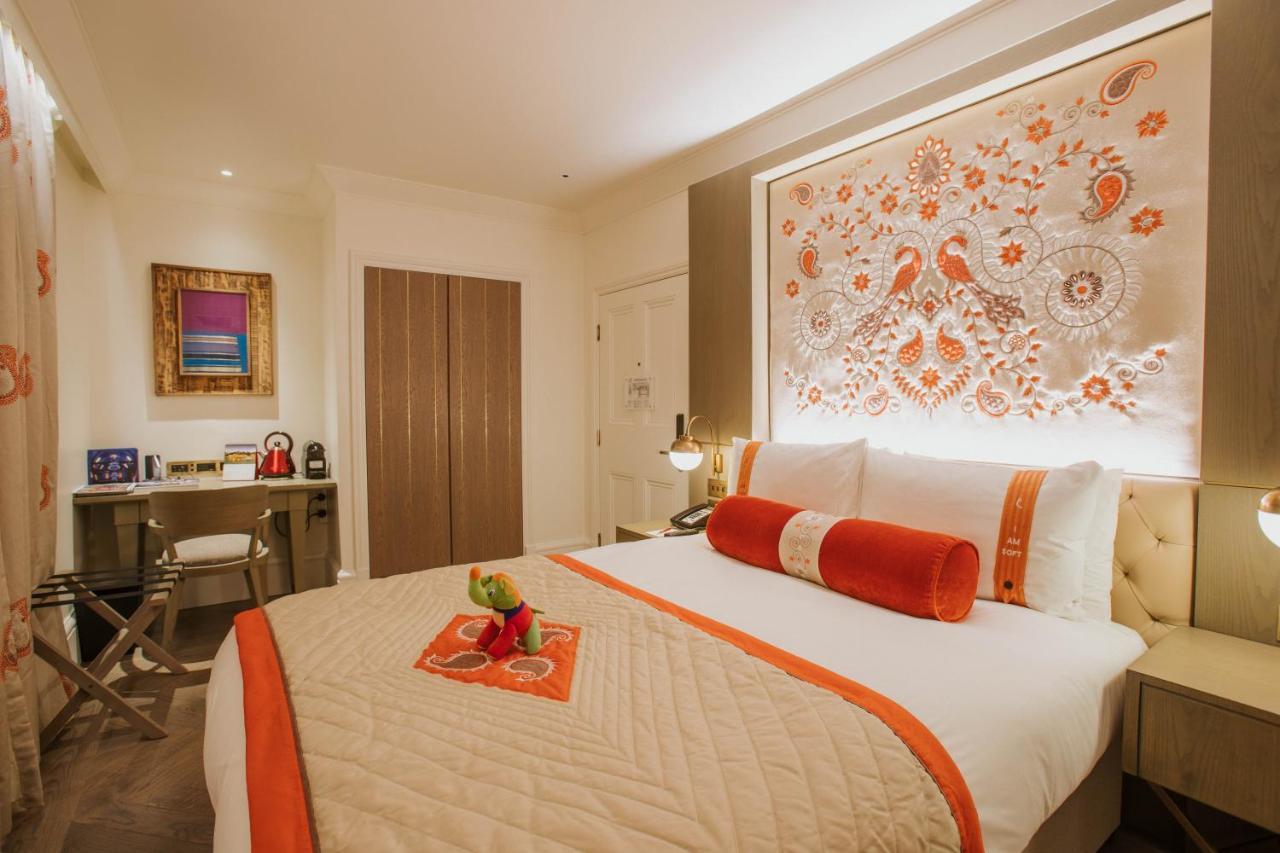 The Lalit London Hotell Exteriör bild A bedroom at The Taj Mahal Palace, Mumbai